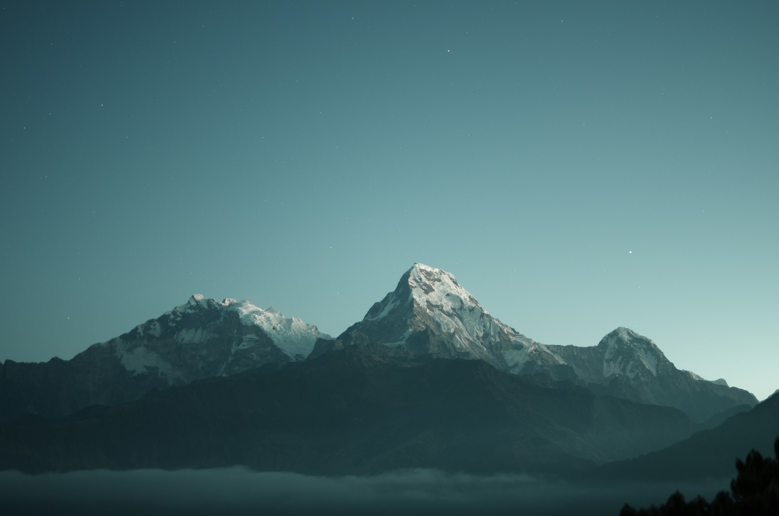 Snowy mountain peaks catching the last evening light