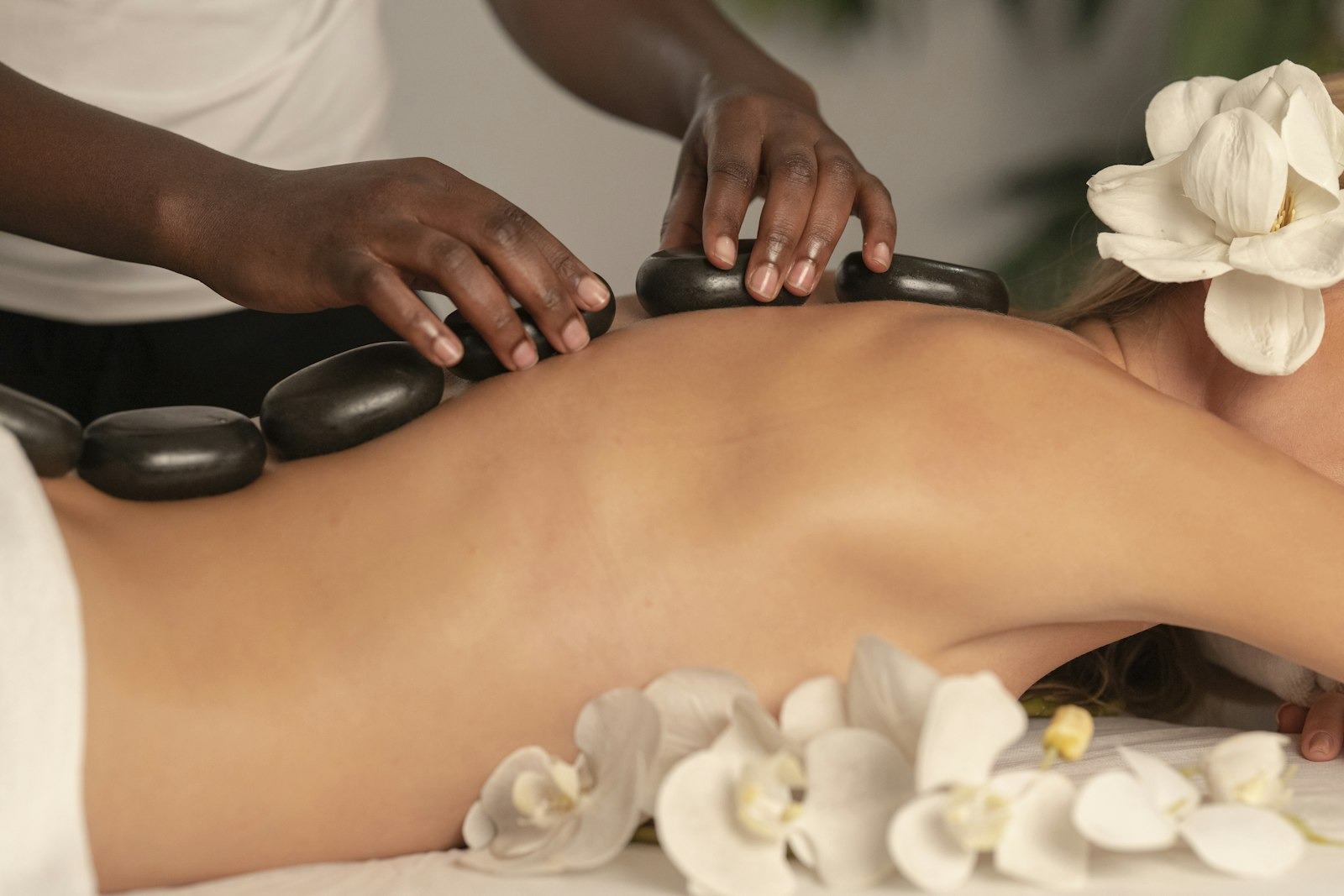 Spa treatment table with towels, flowers and warm candlelight